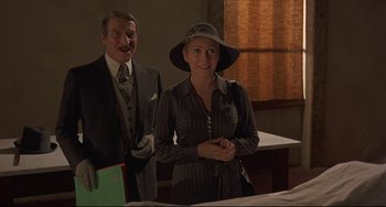 Movie still from “Avanti!” (1972), directed by Billy Wilder – A man and a woman standing next to each other in a room; Medium shot, Over the shoulder angle