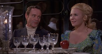 Movie still from “Avanti!” (1972), directed by Billy Wilder – A man and a woman sitting at a dinner table with wine glasses; Medium shot, Over the shoulder angle