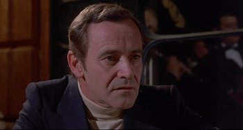 Movie still from “Avanti!” (1972), directed by Billy Wilder – A person wearing a suit and tie; Close Up shot, Low angle