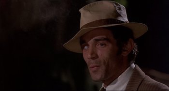 Movie still from “Avanti!” (1972), directed by Billy Wilder – A person wearing a hat; Close Up shot, Over the shoulder angle