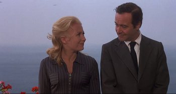 Movie still from “Avanti!” (1972), directed by Billy Wilder – A man and a woman standing next to each other; Close Up shot, Low angle