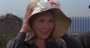 Movie still from “Avanti!” (1972), directed by Billy Wilder – A woman wearing a straw hat with a flower on it; Close Up shot, High angle