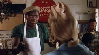 Movie still from “B*A*P*S” (1997), directed by Robert Townsend – A man and a woman in front of a coke sign; Close Up shot, Over the shoulder angle