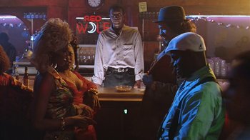 Movie still from “B*A*P*S” (1997), directed by Robert Townsend – A group of people standing around a bar; Medium shot, Low angle