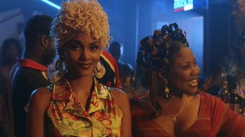 Movie still from “B*A*P*S” (1997), directed by Robert Townsend – Two beautiful women with curly hair posing for a picture; Close Up shot, Low angle