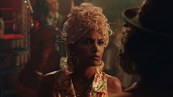 Movie still from “B*A*P*S” (1997), directed by Robert Townsend – A woman with blonde curly hair wearing a floral dress; Close Up shot, Over the shoulder angle