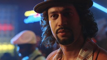 Movie still from “B*A*P*S” (1997), directed by Robert Townsend – A person wearing a hat with lights in the background; Close Up shot, Low angle