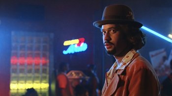 Movie still from “B*A*P*S” (1997), directed by Robert Townsend – A man wearing a hat standing next to a neon sign; Close Up shot, Low angle