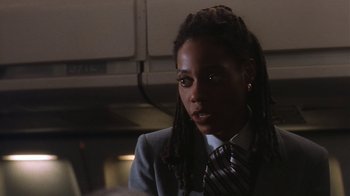 Movie still from “B*A*P*S” (1997), directed by Robert Townsend – A woman in a suit and a tie looking to her left; Close Up shot, Low angle