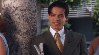 Movie still from “B*A*P*S” (1997), directed by Robert Townsend – A man in a suit and tie holding a knife; Close Up shot, High angle