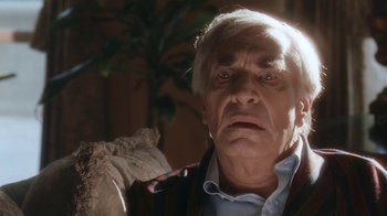 Movie still from “B*A*P*S” (1997), directed by Robert Townsend – An older man with white hair and wearing a blue shirt; Close Up shot, Over the shoulder angle