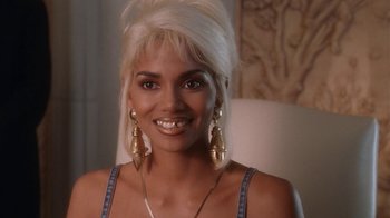 Movie still from “B*A*P*S” (1997), directed by Robert Townsend – A woman with white hair and gold earrings smiling for the camera; Close Up shot, High angle
