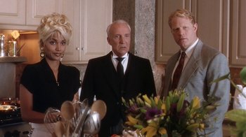 Movie still from “B*A*P*S” (1997), directed by Robert Townsend – A group of people standing around a table with flowers on top of it; Medium shot, Over the shoulder angle