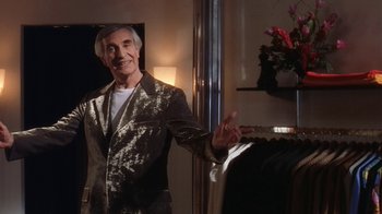 Movie still from “B*A*P*S” (1997), directed by Robert Townsend – A man wearing a suit and tie in a room; Medium shot, Low angle