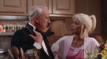 Movie still from “B*A*P*S” (1997), directed by Robert Townsend – An older man and a young woman in a kitchen; Medium shot, Low angle