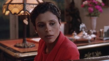 Movie still from “B*A*P*S” (1997), directed by Robert Townsend – A person sitting at a table; Close Up shot, High angle
