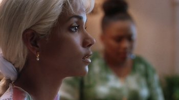 Movie still from “B*A*P*S” (1997), directed by Robert Townsend – A woman with blonde hair looking to her left; Close Up shot, Over the shoulder angle