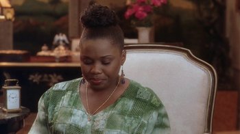 Movie still from “B*A*P*S” (1997), directed by Robert Townsend – A woman sitting in a chair with her eyes closed; Close Up shot, High angle