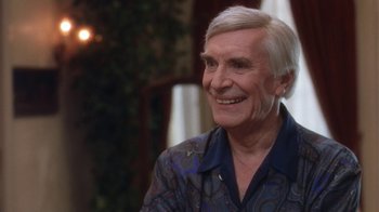 Movie still from “B*A*P*S” (1997), directed by Robert Townsend – An older man with white hair smiling for the camera; Close Up shot, Over the shoulder angle