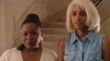 Movie still from “B*A*P*S” (1997), directed by Robert Townsend – Two women standing next to each other in front of a staircase; Close Up shot, Low angle