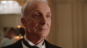 Movie still from “B*A*P*S” (1997), directed by Robert Townsend – An older man wearing a suit and bow tie; Close Up shot, Low angle