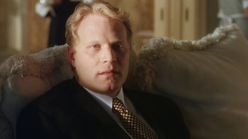 Movie still from “B*A*P*S” (1997), directed by Robert Townsend – A person wearing a suit and tie; Close Up shot, Low angle