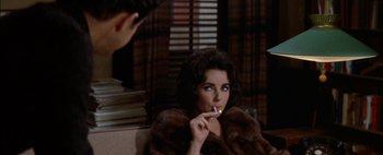 Movie still from “BUtterfield 8” (1960), directed by Daniel Mann – A woman in a fur coat brushing her teeth; Close Up shot, Over the shoulder angle
