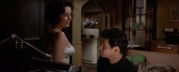 Movie still from “BUtterfield 8” (1960), directed by Daniel Mann – A man and a woman are looking at one another; Medium shot, Over the shoulder angle