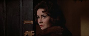 Movie still from “BUtterfield 8” (1960), directed by Daniel Mann – A person wearing a fur coat; Close Up shot, Over the shoulder angle