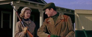 Movie still from “BUtterfield 8” (1960), directed by Daniel Mann – A man and a woman are standing in front of a house; Close Up shot, Low angle