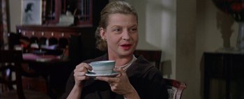 Movie still from “BUtterfield 8” (1960), directed by Daniel Mann – A woman holding a cup of coffee in her hands; Close Up shot, Over the shoulder angle