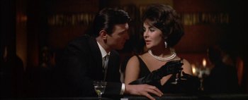 Movie still from “BUtterfield 8” (1960), directed by Daniel Mann – A man and a woman sitting at a bar; Close Up shot, Low angle