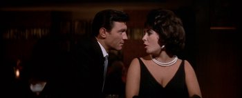 Movie still from “BUtterfield 8” (1960), directed by Daniel Mann – A man and a woman sitting next to each other at a table; Close Up shot, Low angle