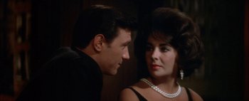 Movie still from “BUtterfield 8” (1960), directed by Daniel Mann – A man and a woman looking at one another; Close Up shot, Over the shoulder angle