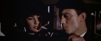 Movie still from “BUtterfield 8” (1960), directed by Daniel Mann – A man and a woman looking at one another in a mirror; Close Up shot, Over the shoulder angle