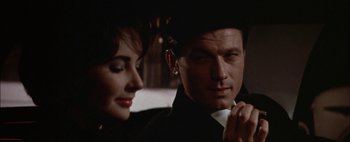 Movie still from “BUtterfield 8” (1960), directed by Daniel Mann – A man and a woman sitting next to each other; Close Up shot, Over the shoulder angle