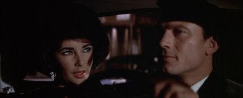 Movie still from “BUtterfield 8” (1960), directed by Daniel Mann – A man and a woman sitting in the back of a car; Close Up shot, Over the shoulder angle