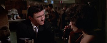 Movie still from “BUtterfield 8” (1960), directed by Daniel Mann – A man and a woman are drinking red wine; Close Up shot, Over the shoulder angle