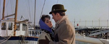 Movie still from “BUtterfield 8” (1960), directed by Daniel Mann – A man and a woman standing next to each other on a boat; Close Up shot, Low angle