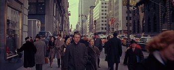 Movie still from “BUtterfield 8” (1960), directed by Daniel Mann – A crowd of people walking down a city street; Wide shot, High angle