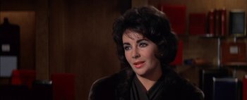 Movie still from “BUtterfield 8” (1960), directed by Daniel Mann – A person sitting in a chair; Close Up shot, Over the shoulder angle