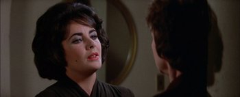 Movie still from “BUtterfield 8” (1960), directed by Daniel Mann – A person looking at a mirror; Close Up shot, Over the shoulder angle