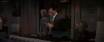 Movie still from “BUtterfield 8” (1960), directed by Daniel Mann – A man and a woman standing in front of each other; Medium shot, High angle