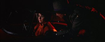 Movie still from “BUtterfield 8” (1960), directed by Daniel Mann – A man and a woman sitting in the back seat of a car; Close Up shot, Over the shoulder angle