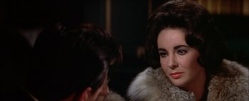 Movie still from “BUtterfield 8” (1960), directed by Daniel Mann – A man and a woman are looking at one another; Close Up shot, Over the shoulder angle