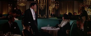 Movie still from “BUtterfield 8” (1960), directed by Daniel Mann – A man and a woman sitting at a table in a restaurant; Medium shot, Over the shoulder angle