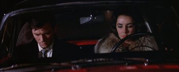 Movie still from “BUtterfield 8” (1960), directed by Daniel Mann – A woman sitting in the driver's seat of a car; Close Up shot, Over the shoulder angle