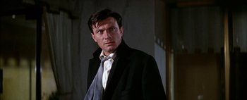 Movie still from “BUtterfield 8” (1960), directed by Daniel Mann – A person wearing a suit and tie; Close Up shot, Low angle