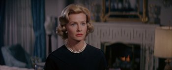 Movie still from “BUtterfield 8” (1960), directed by Daniel Mann – An older woman wearing a black dress and pearl necklace; Close Up shot, Over the shoulder angle