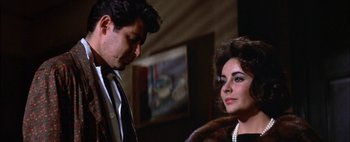 Movie still from “BUtterfield 8” (1960), directed by Daniel Mann – A man and a woman standing next to each other in a room; Close Up shot, Over the shoulder angle